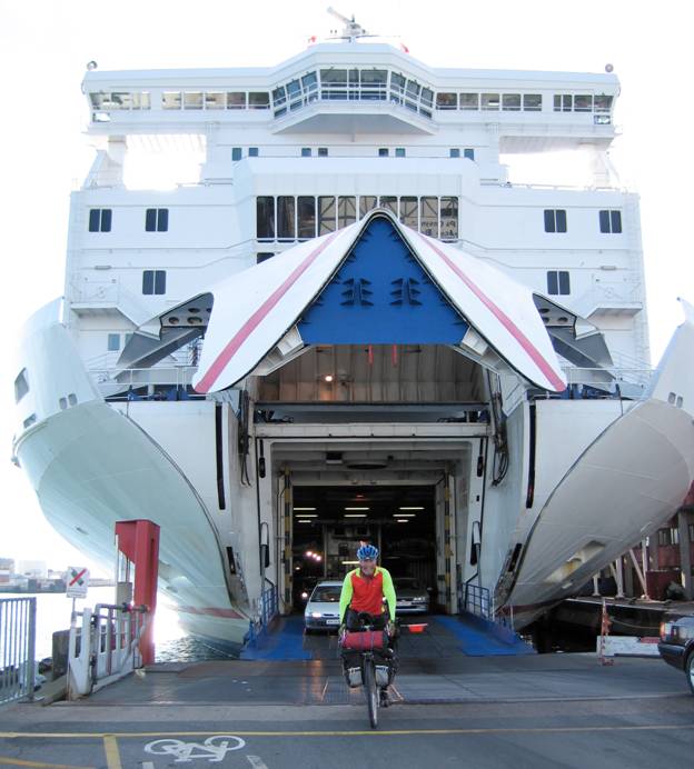 Touring cyclist exiting ferry, Lofotan Island, Norway © 2012 Frosty Wooldridge