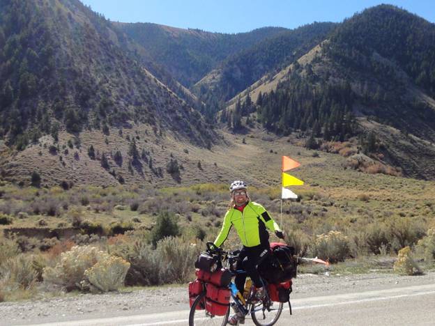 Touring cyclist riding into the Land of the Sleeping Rainbows, Utah © 2012 Frosty Wooldridge